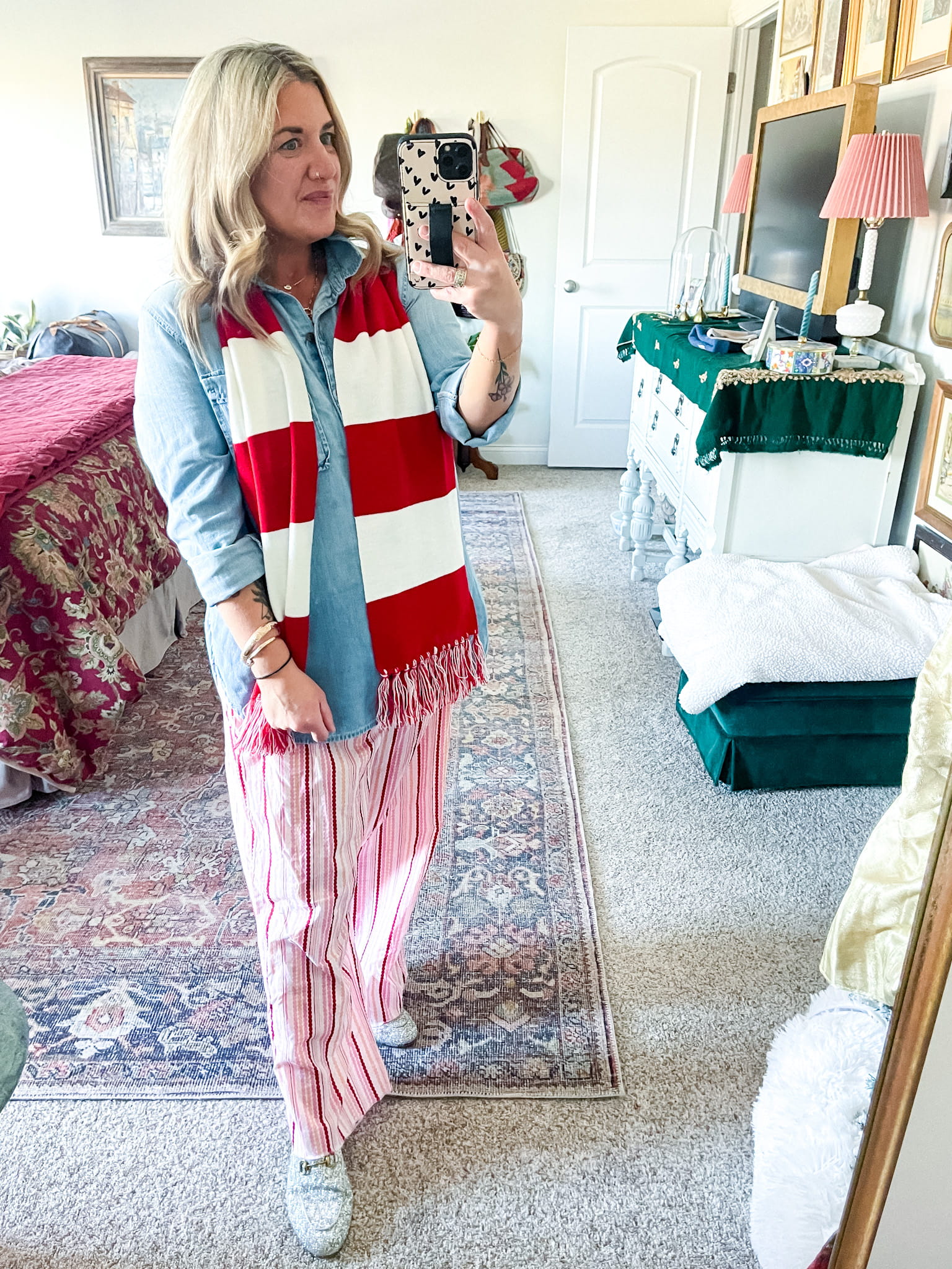 outfit inspiration: woman in a denim/chambray shirt, red and white pajama style pants, red and white striped scarf, and sparkly Gucci mules