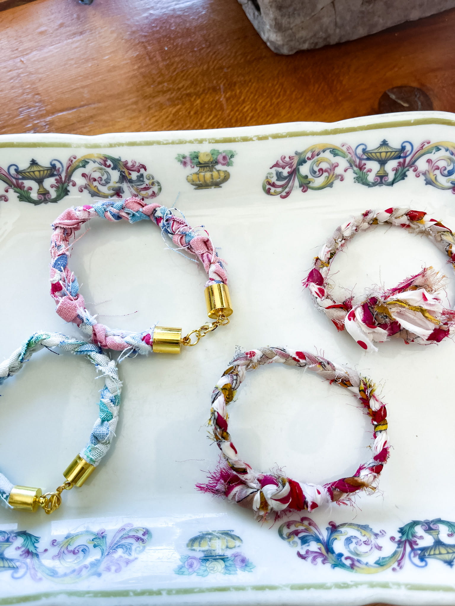 braided bracelets made from vintage fabric on an ironstone dish