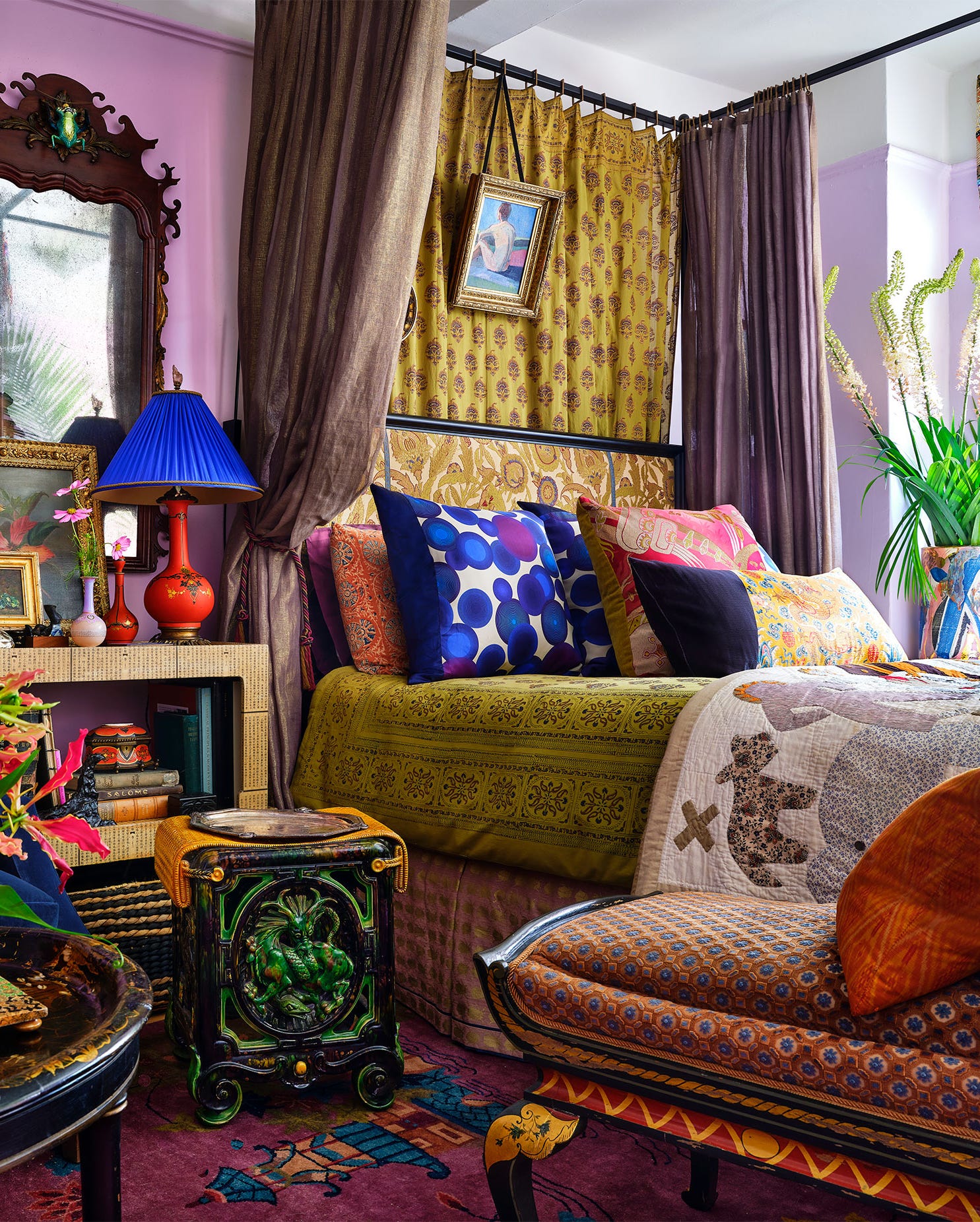 boho bedroom designed by william cullum with multicolored pillows in different textiles