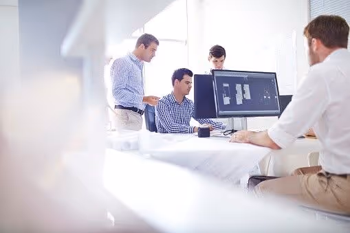 A team of expert outsourced engineers works on a project for an auto client.