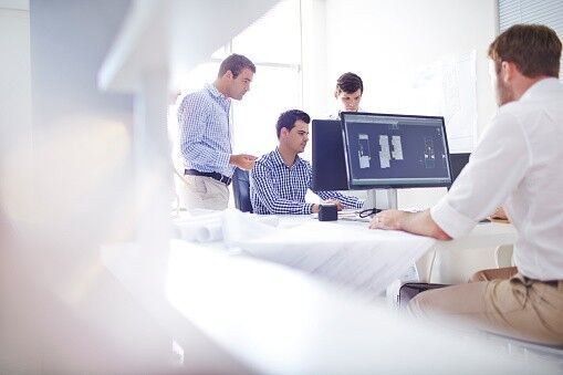 A team of expert outsourced engineers works on a project for an auto client.