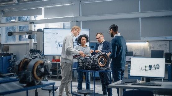 Diverse Intelligent Engineers Work Together on Functions Modification of Electric Engine for Innovative Project. Engineering and Sustainable Energy Technologies for Modern Vehicles Concept.
