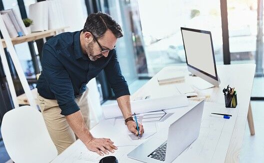 Shot of a mature male architect using his laptop