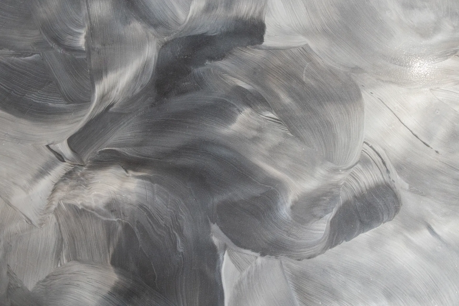 Close-up of silver and charcoal metallic epoxy swirl pattern on showroom floor at Miller Brothers Hardwood in Salesville, Ohio.
