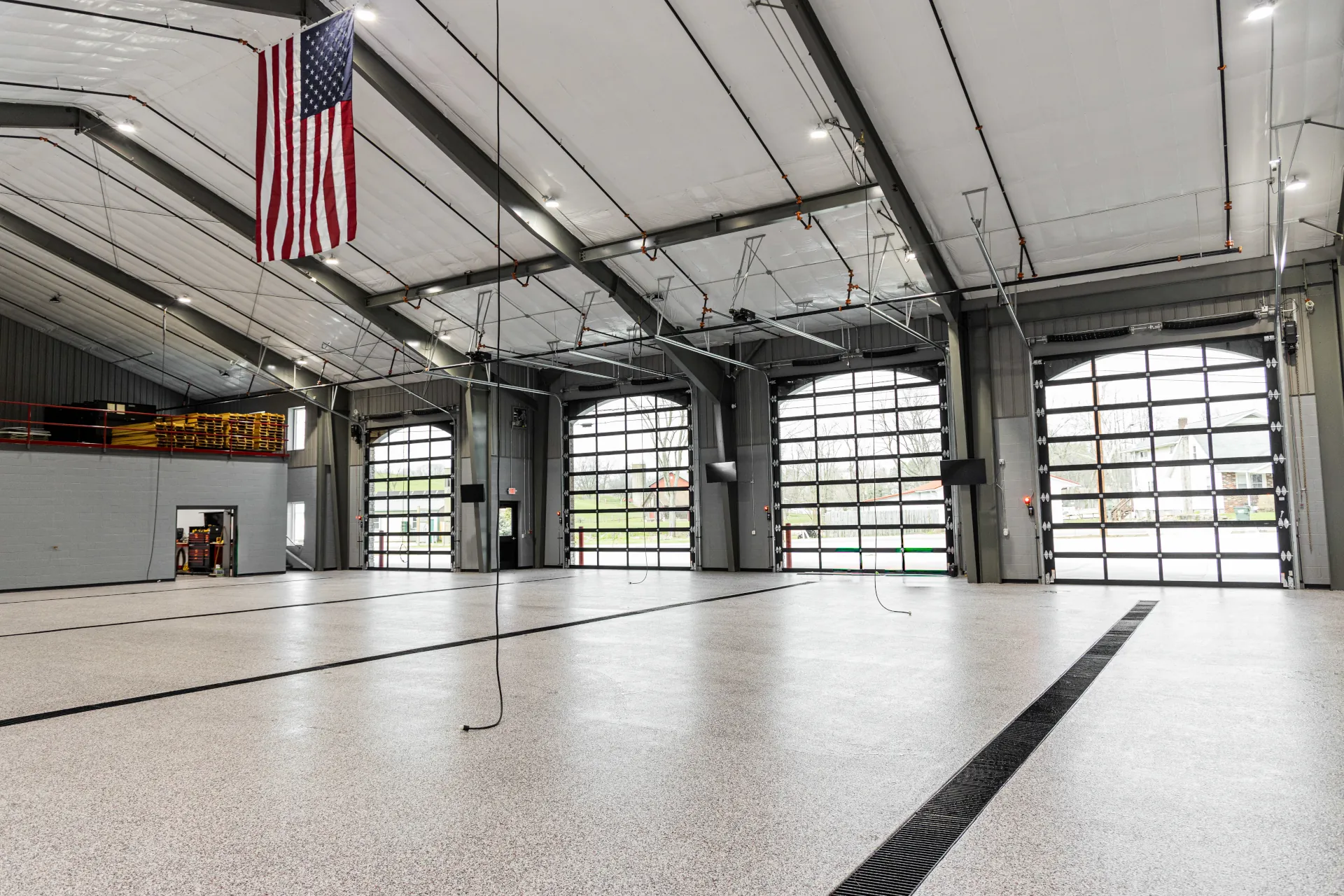 Interior overview of the new Fredericksburg Fire Station with decorative flake floor coating throughout apparatus bays.