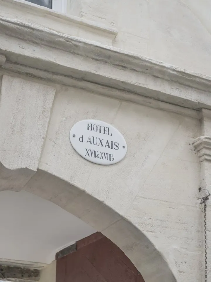 The Hôtel d’Auxais plaque above the carriage entrance