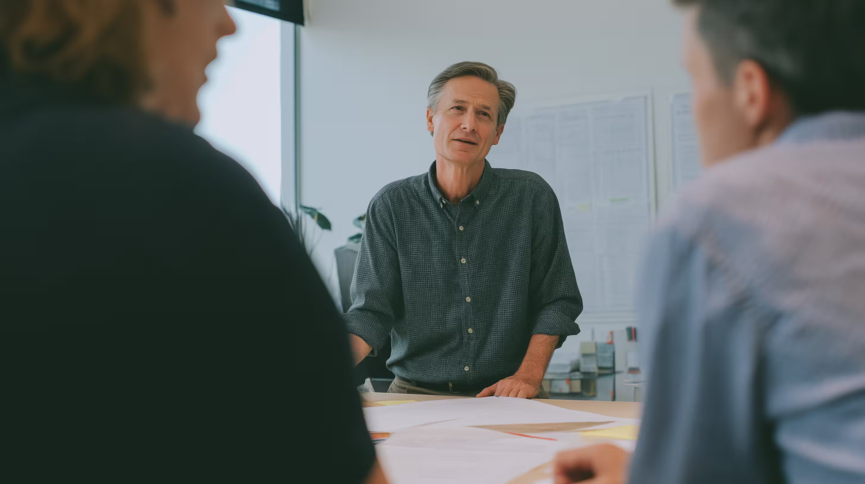 A leader in a meeting that captures growth and clarity, showing what is executive coaching.