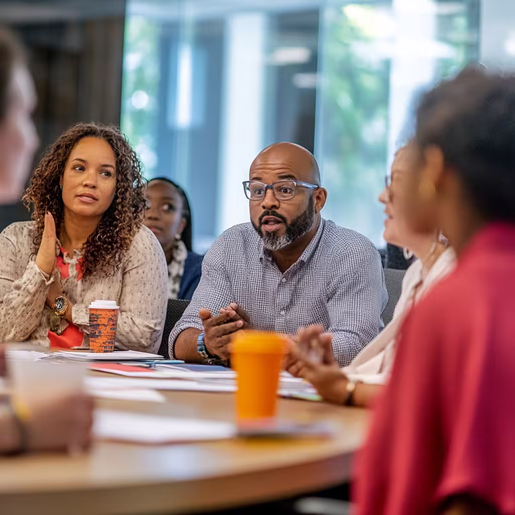 Diverse group of professionals engaged in a collaborative workshop as part of hands-on leadership training programs.