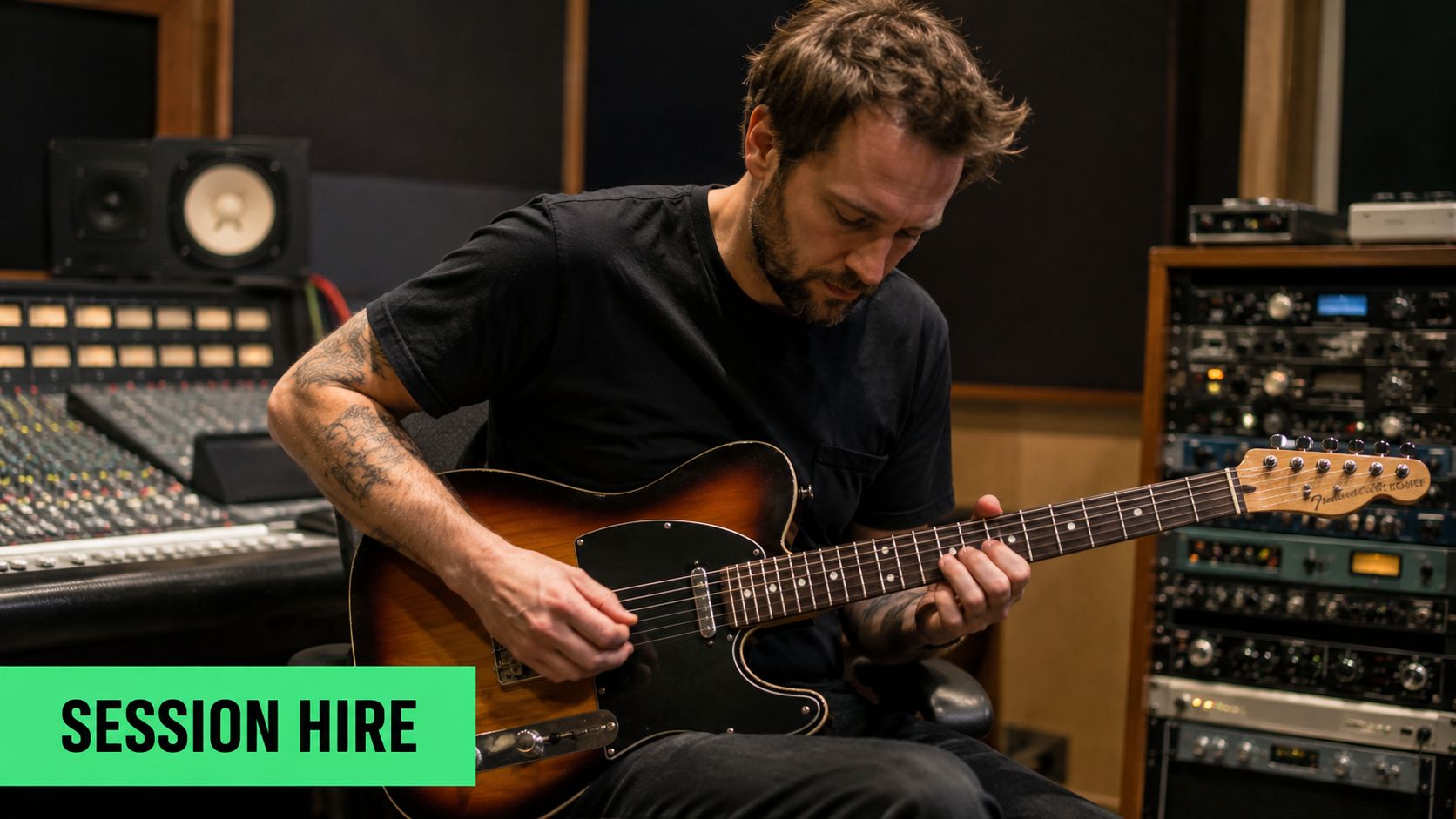 A professional musician playing an electric guitar in a music recording studio while performing session work.