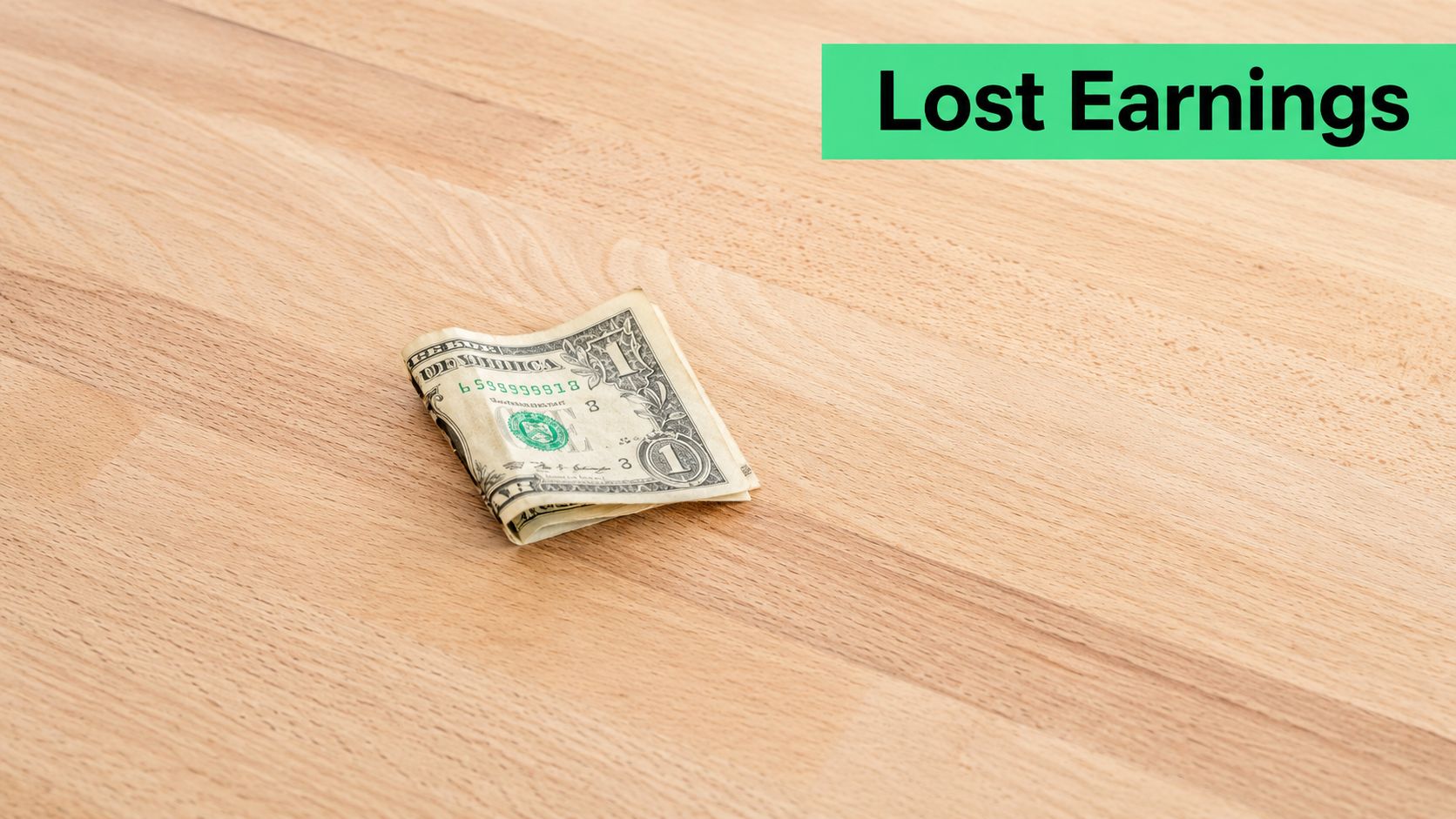 A single folded one-dollar bill sitting on a light-colored wooden table representing financial lost earnings.