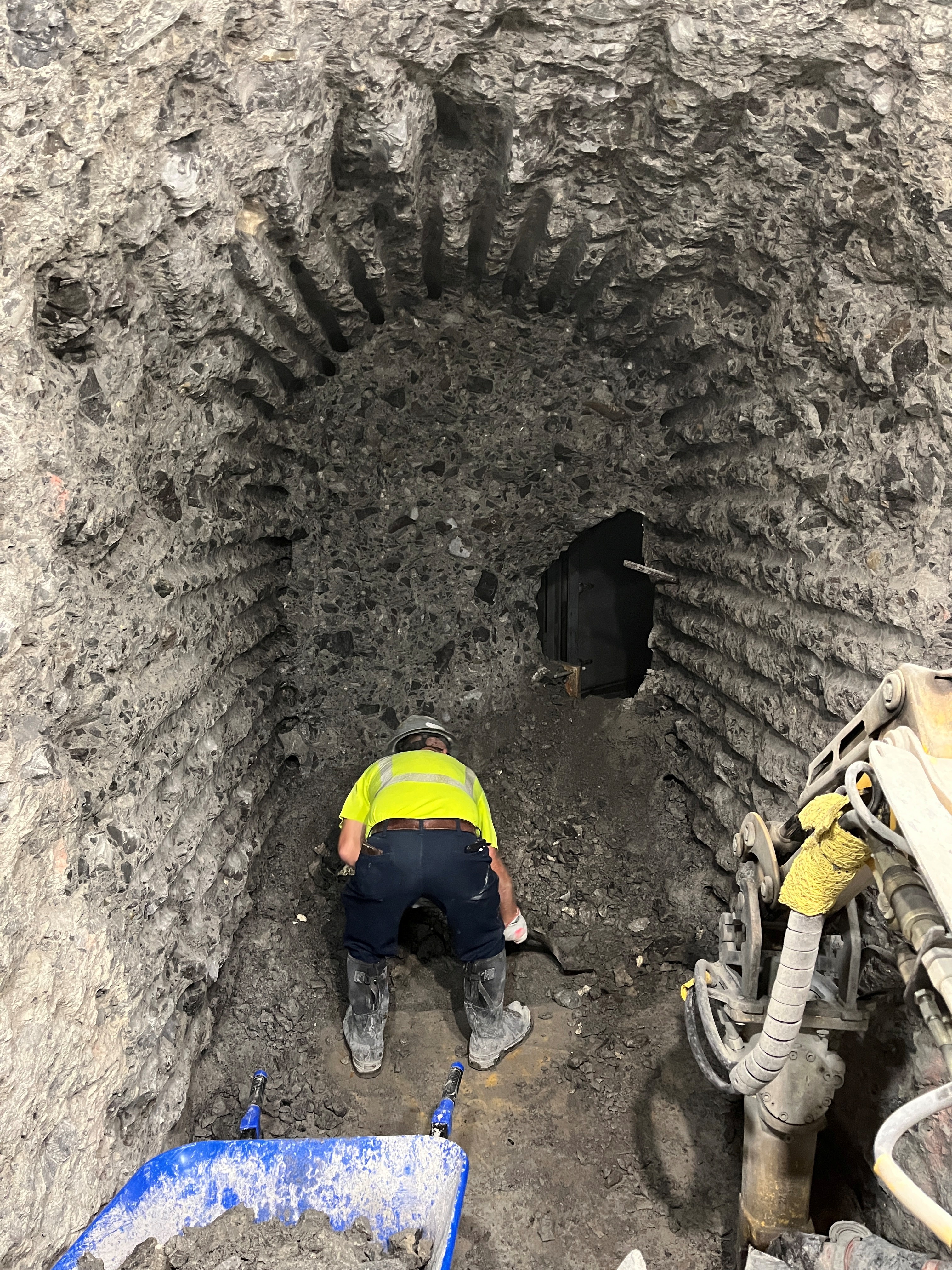 A worker in a yellow vest clearing the tunnel