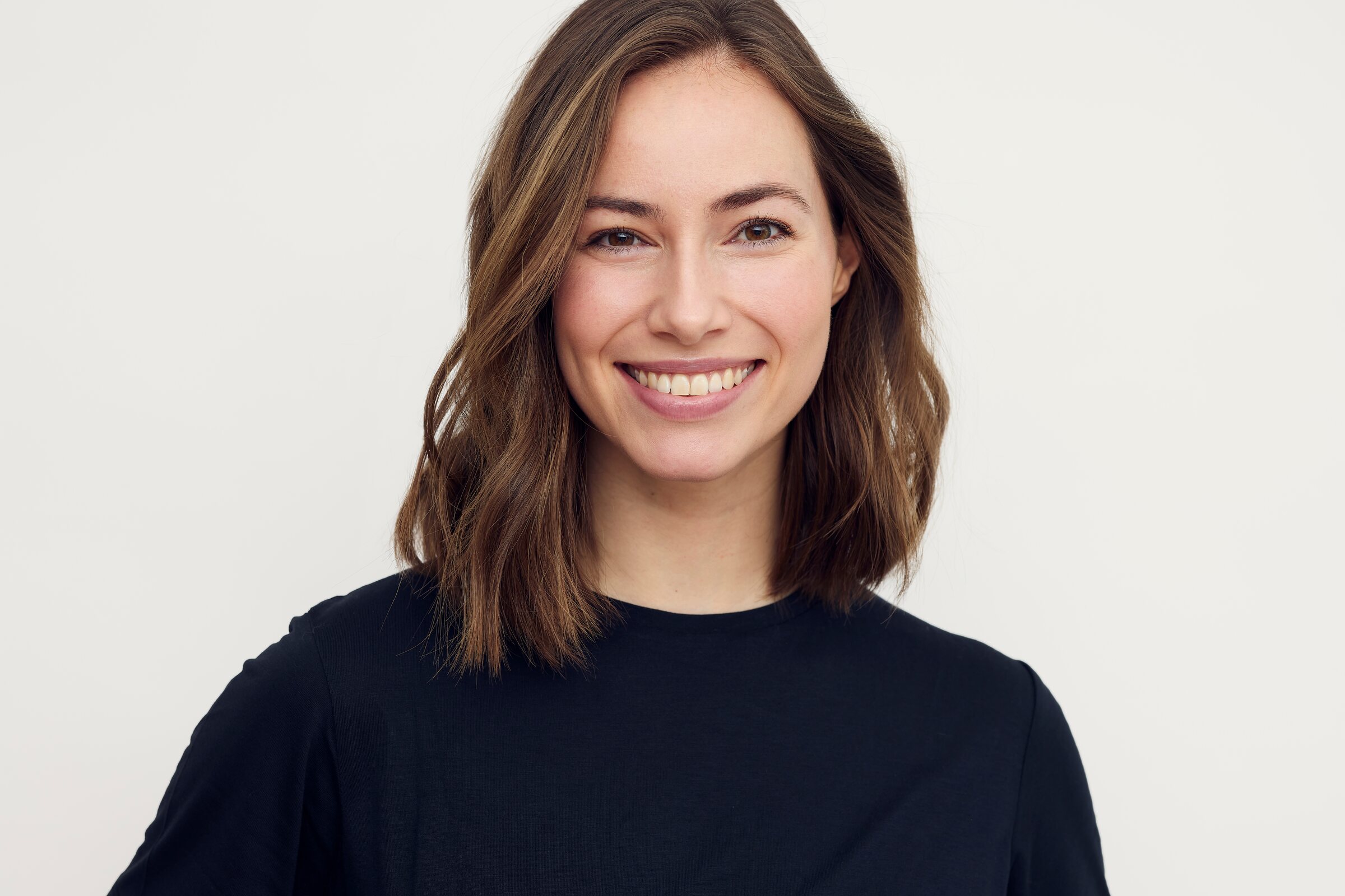 Woman with clear, even skin tone photographed in soft natural light