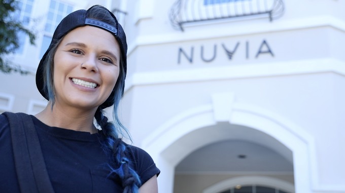 Smiling woman outside of the Nuvia office in Dallas