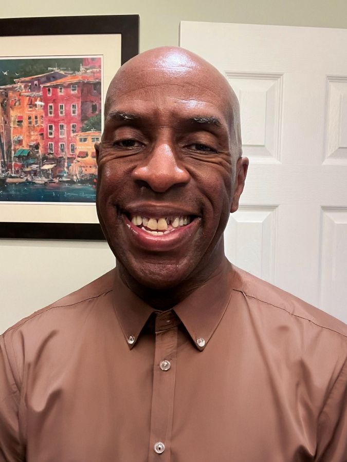 Man smiling before getting his new teeth