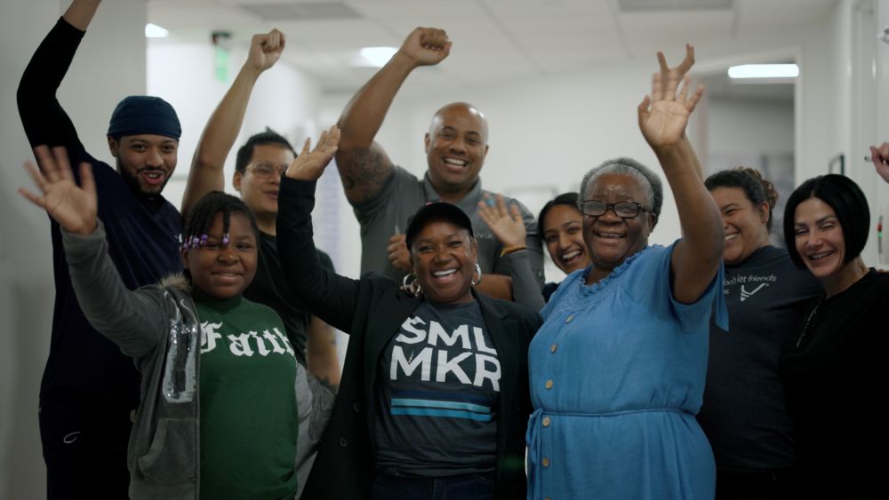 Lynette surrounded b family and staff celebrating her new smile
