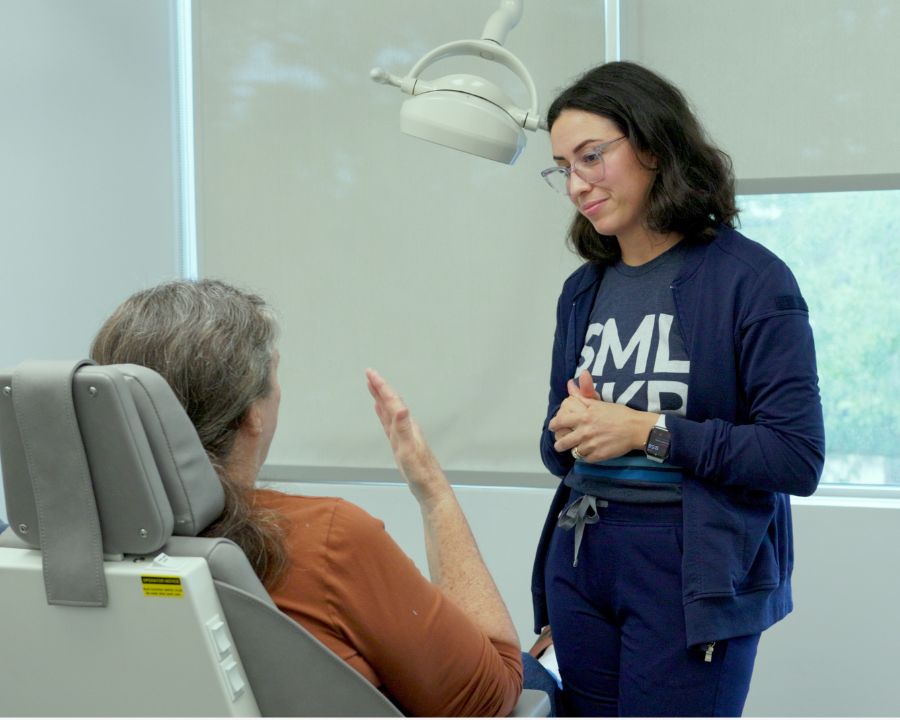 Dr. Annoni talking with a patient answering questions about permanent teeth in 24 hoursn