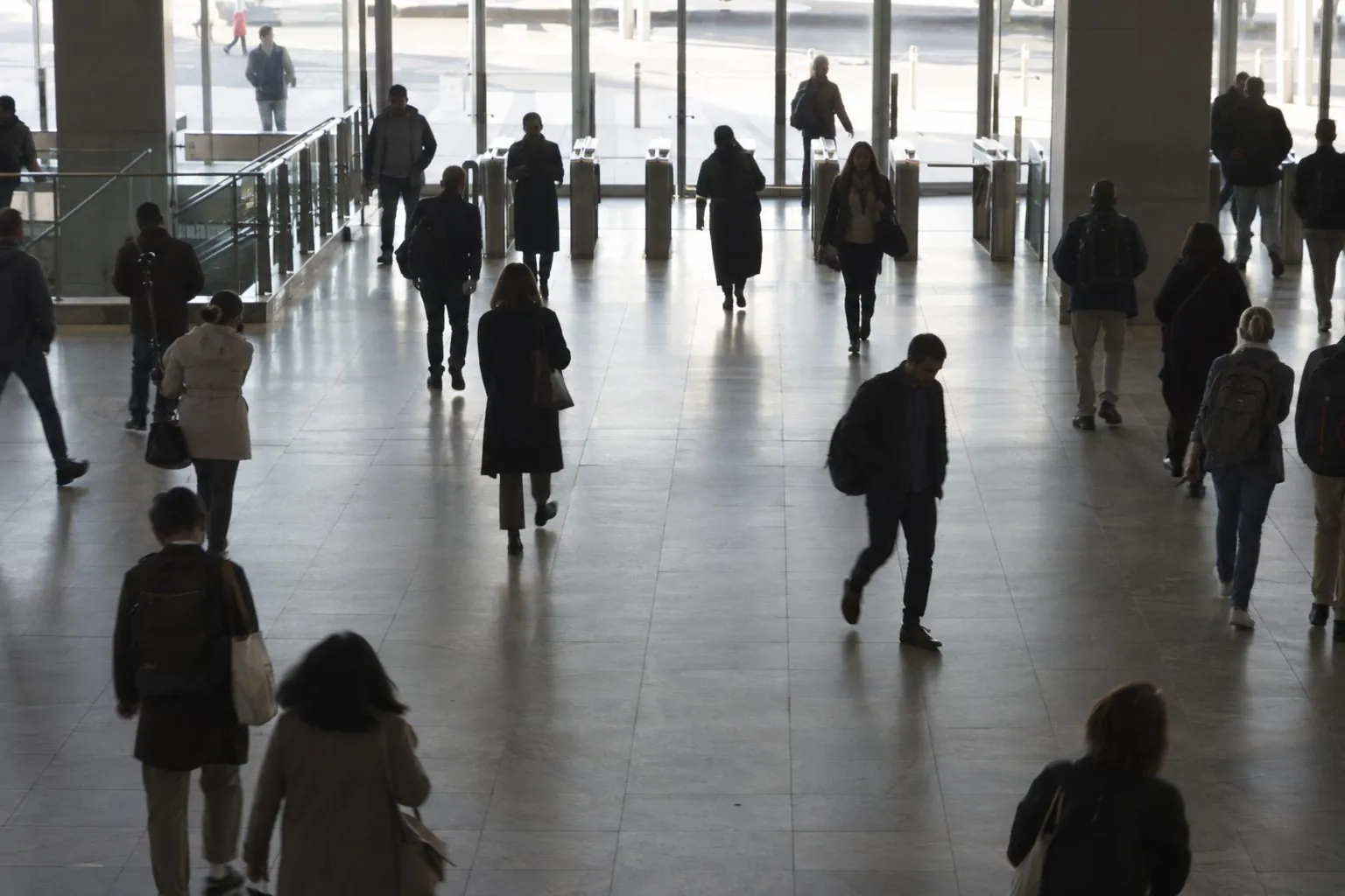 Commuters walking through a station entrance. Face boxes are struck out and not collected. Only a chemical trace from one backpack is flagged.