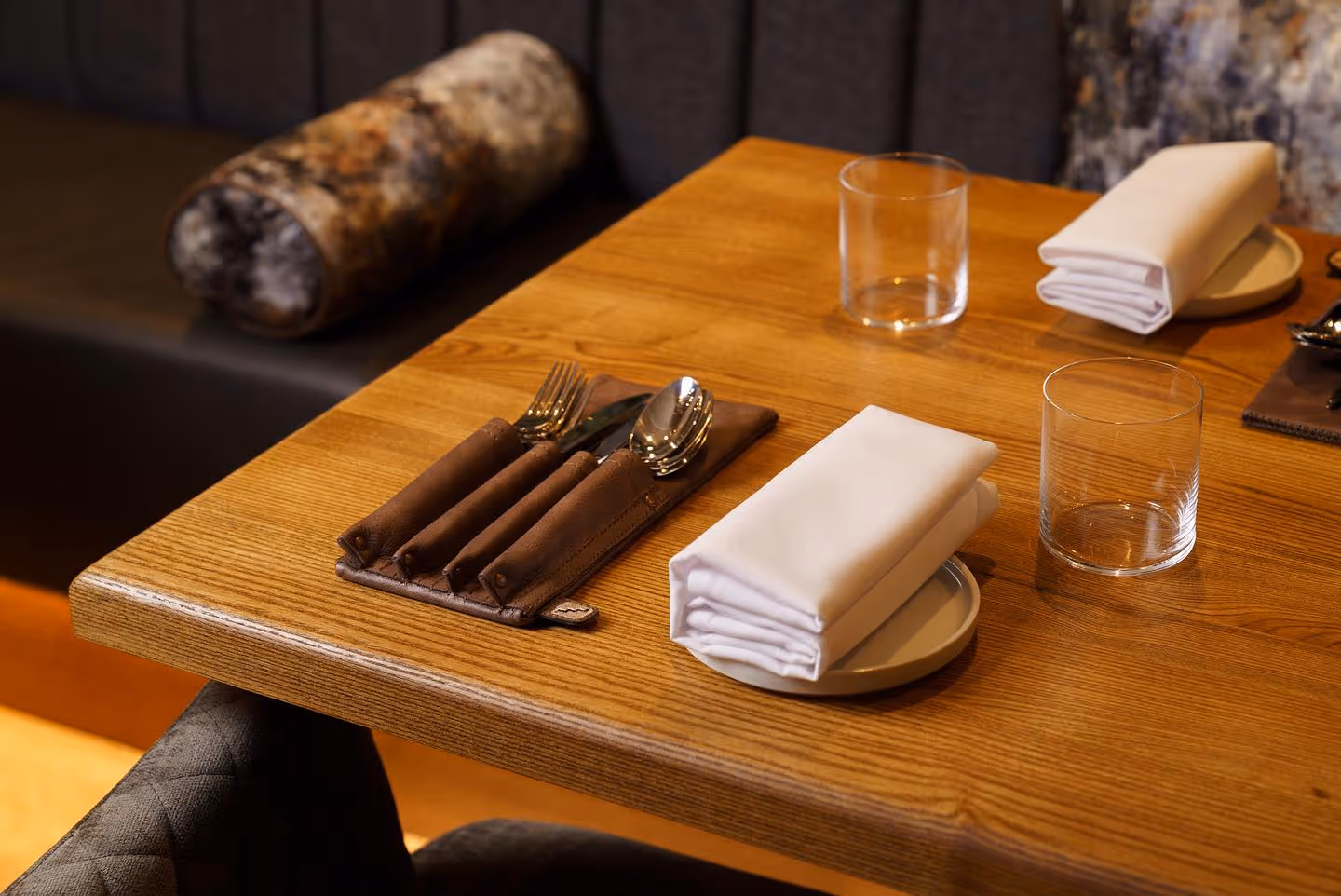 A table set with a napkin, fork, and knife.