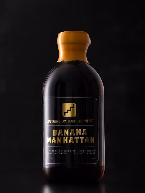 A bottle of Banana Manhattan by the bottle made by Upstaris by Tom Shepherd