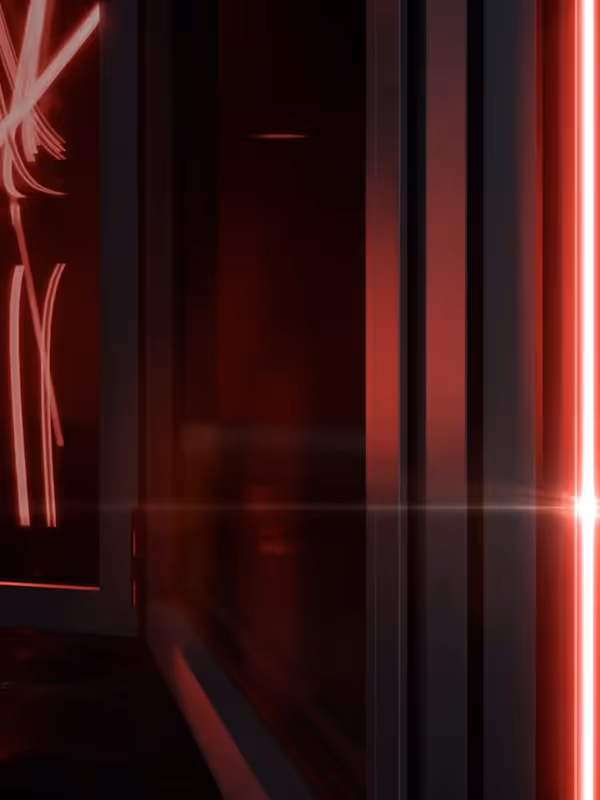 Sleek aluminium door frame bathed in ambient red lighting, hinting at modern design and precision engineering.