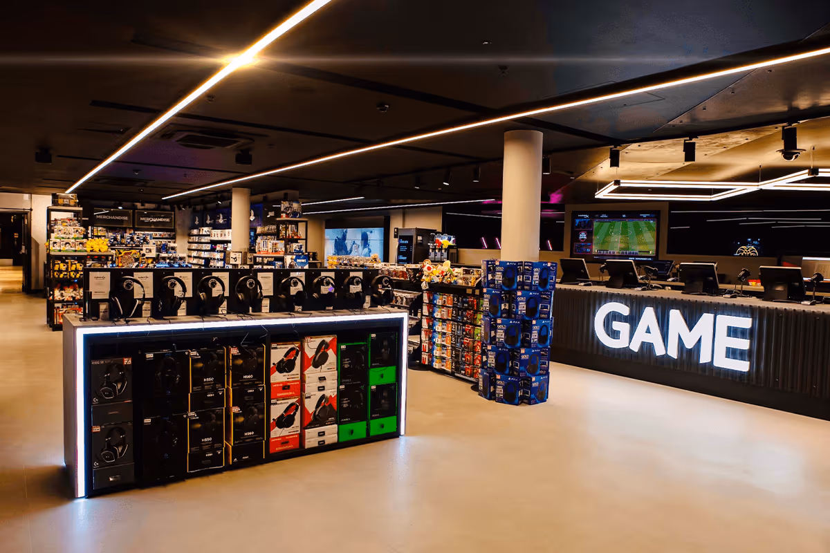 Interior of GAME store showcasing a well-lit space with merchandise displays, gaming accessories, and a prominent GAME logo on the store's front counter.