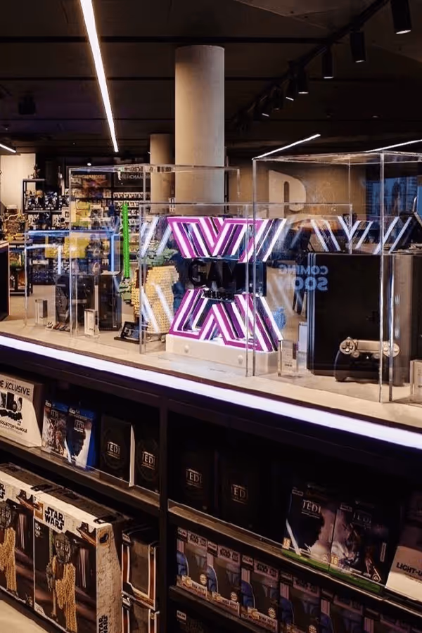 Interior of the GAME store, featuring shelves stocked with various gaming merchandise, ambient lighting.