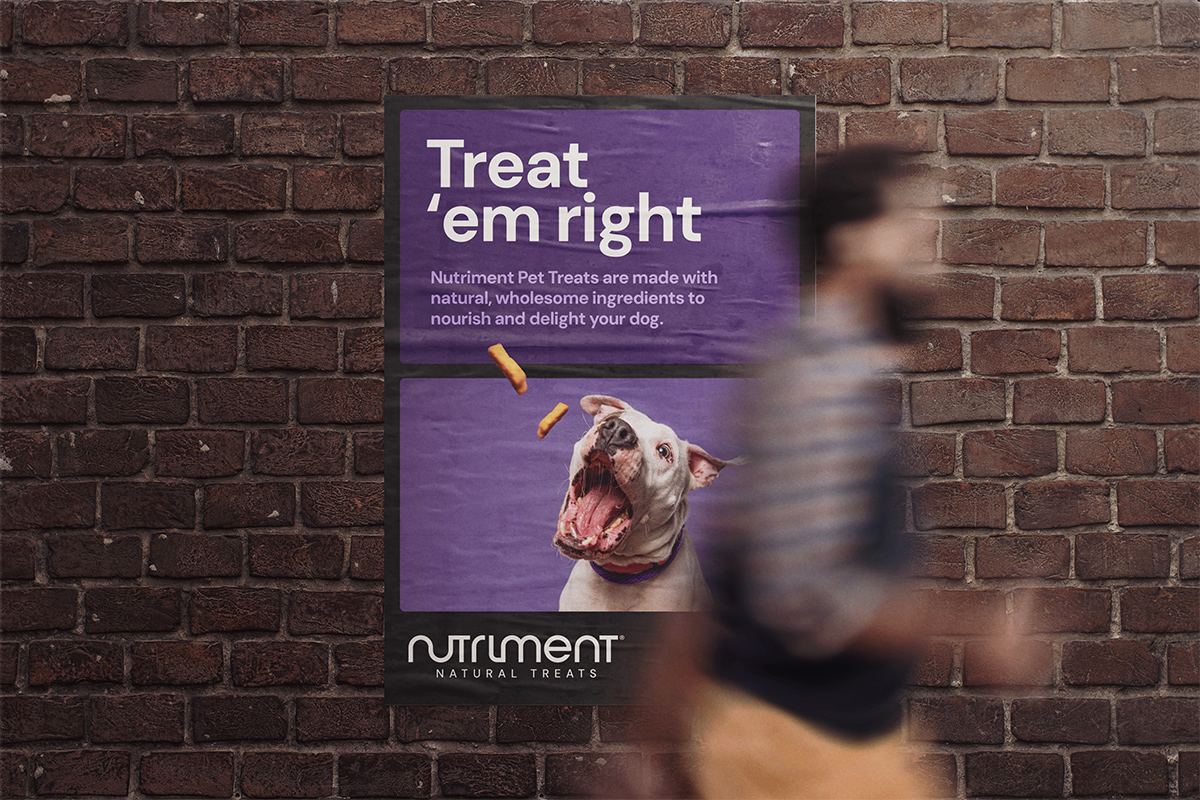 Treat 'em right poster on a brick wall showing Nurtiment brand and a dog catching the treat