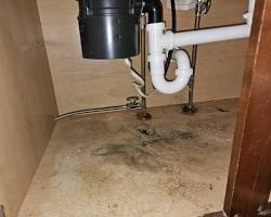 Image of leaking plumbing pipe under sink with wood rot damage vs repaired pipe