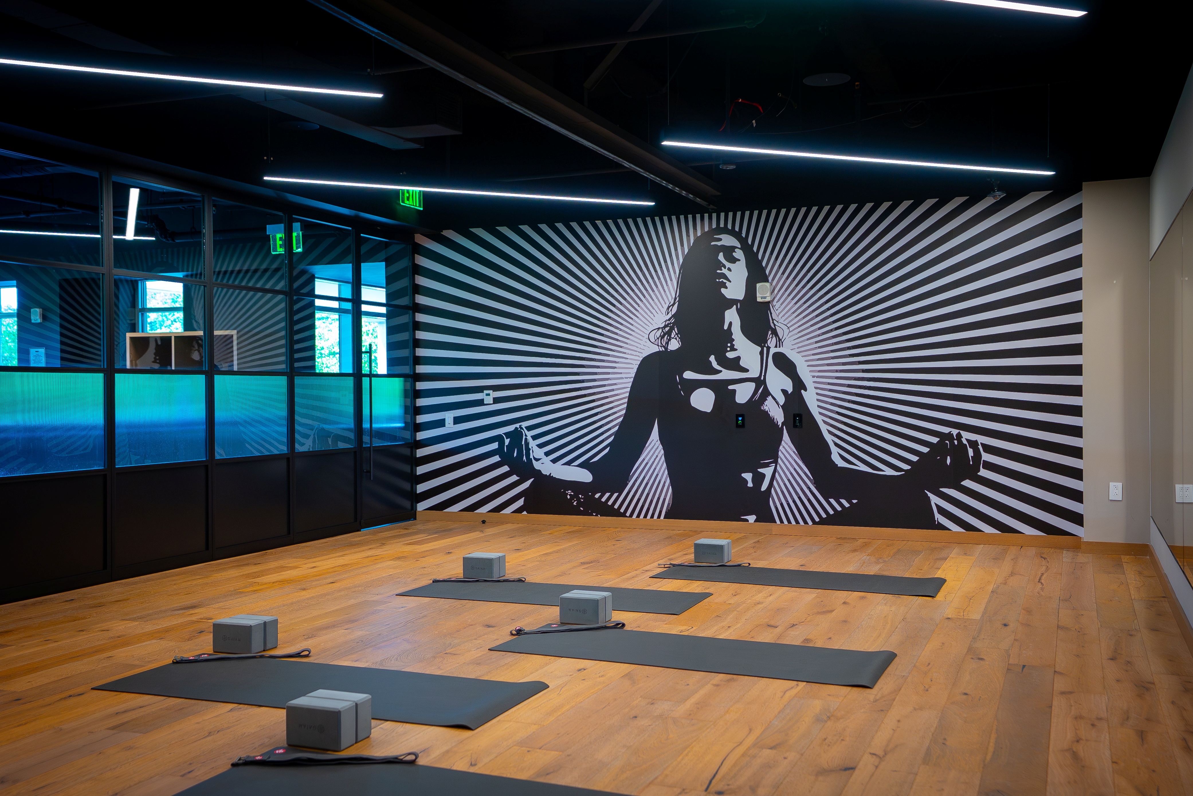 Clean, organized gym floor at FIELDHOUSE featuring modern fitness equipment and open workout space.