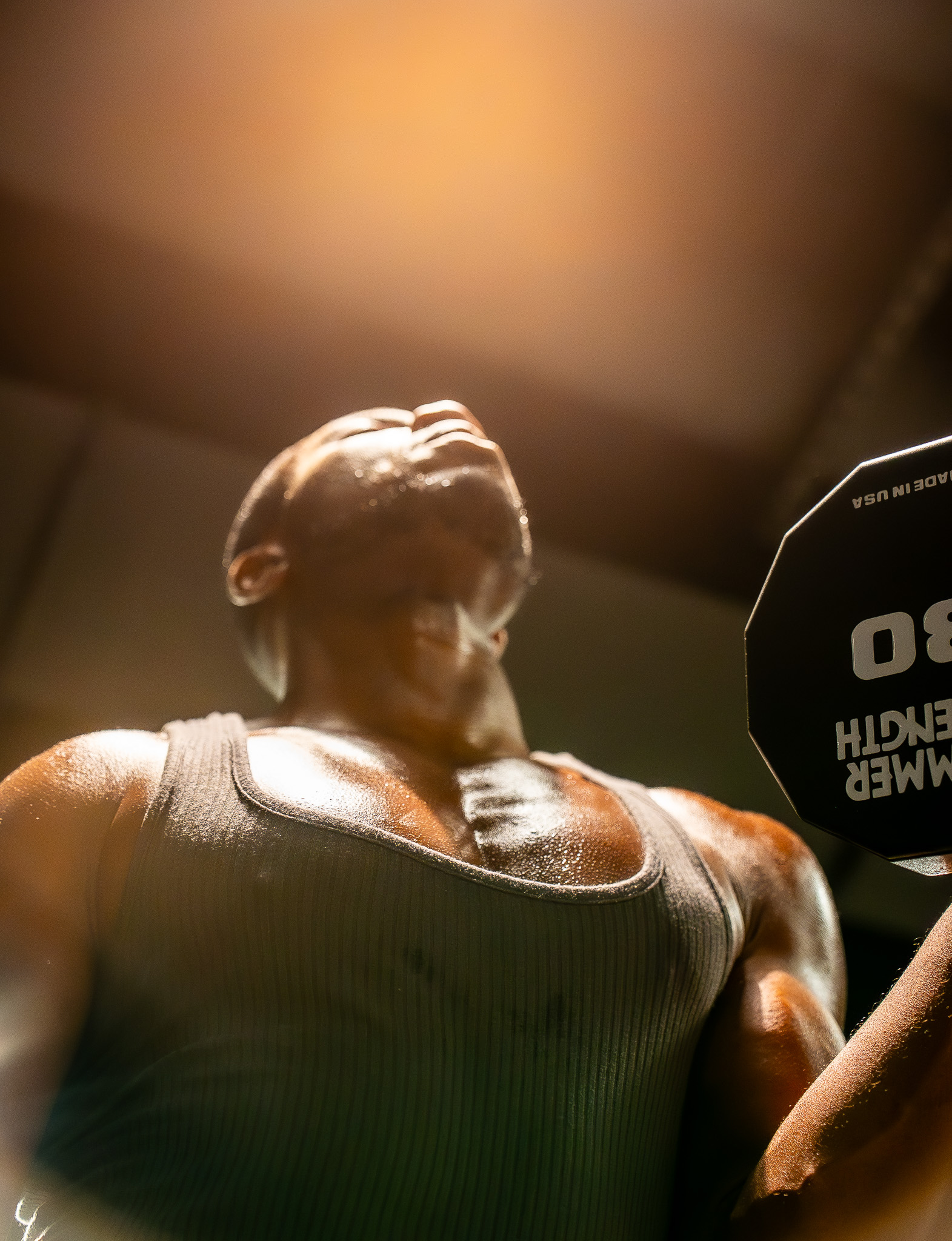 Member strength training with free weights at FIELDHOUSE gym.