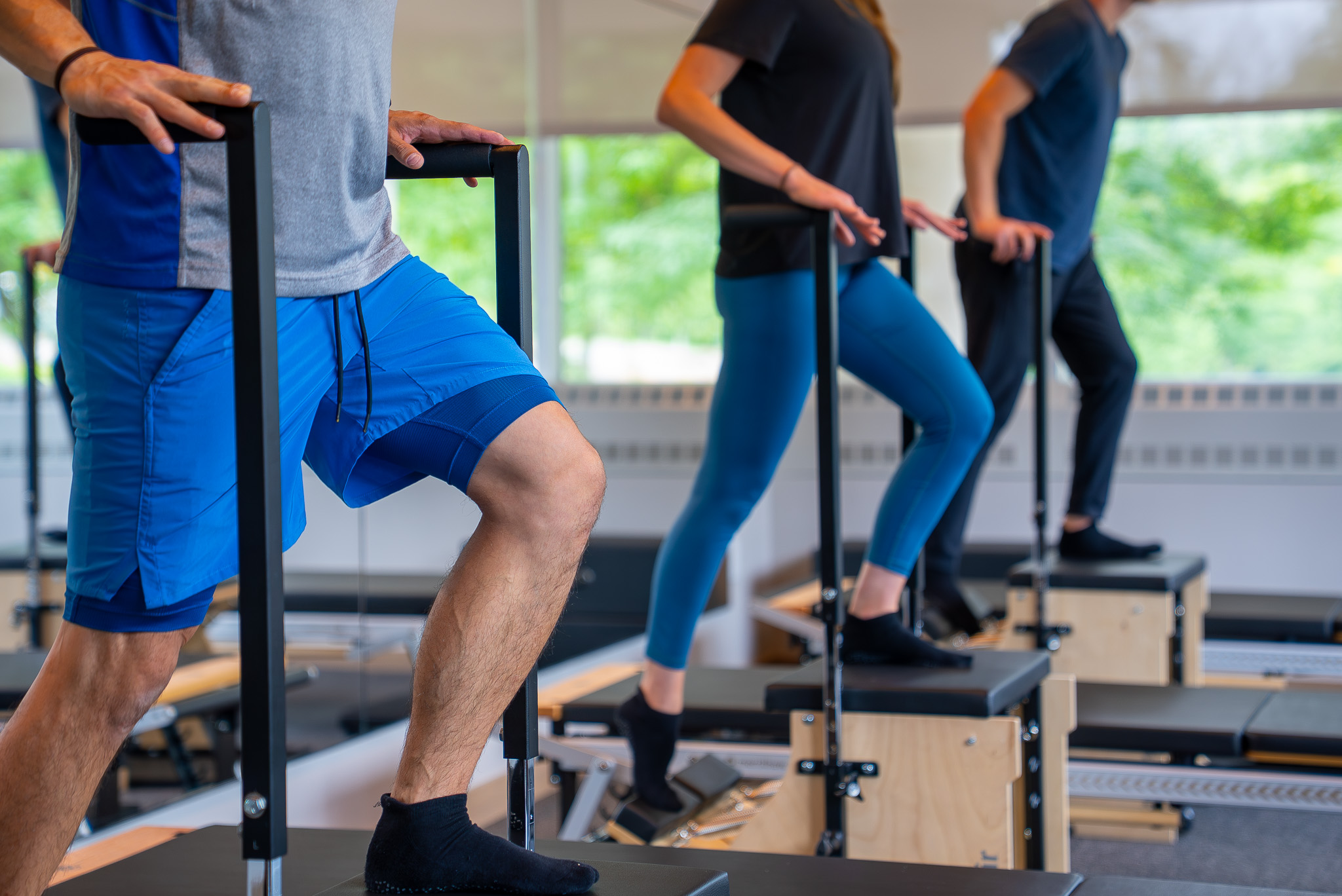 Members taking a semi private reformer Pilates class.