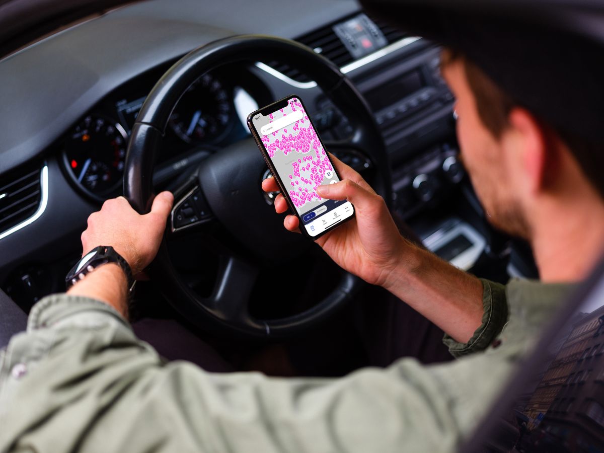 Paua B2B EV charging card app over shoulder of driver in van