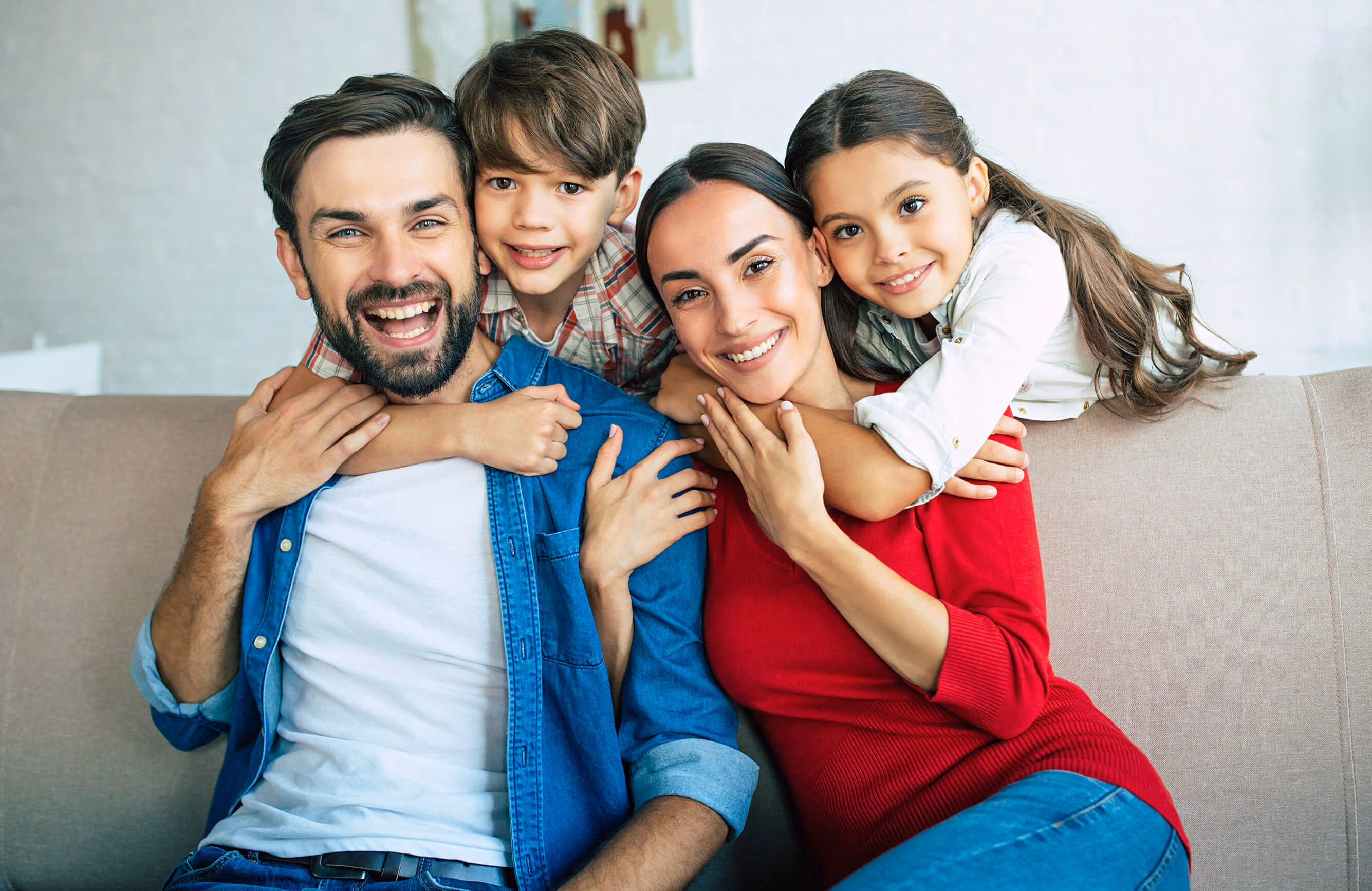 Family of four sitting on a couch