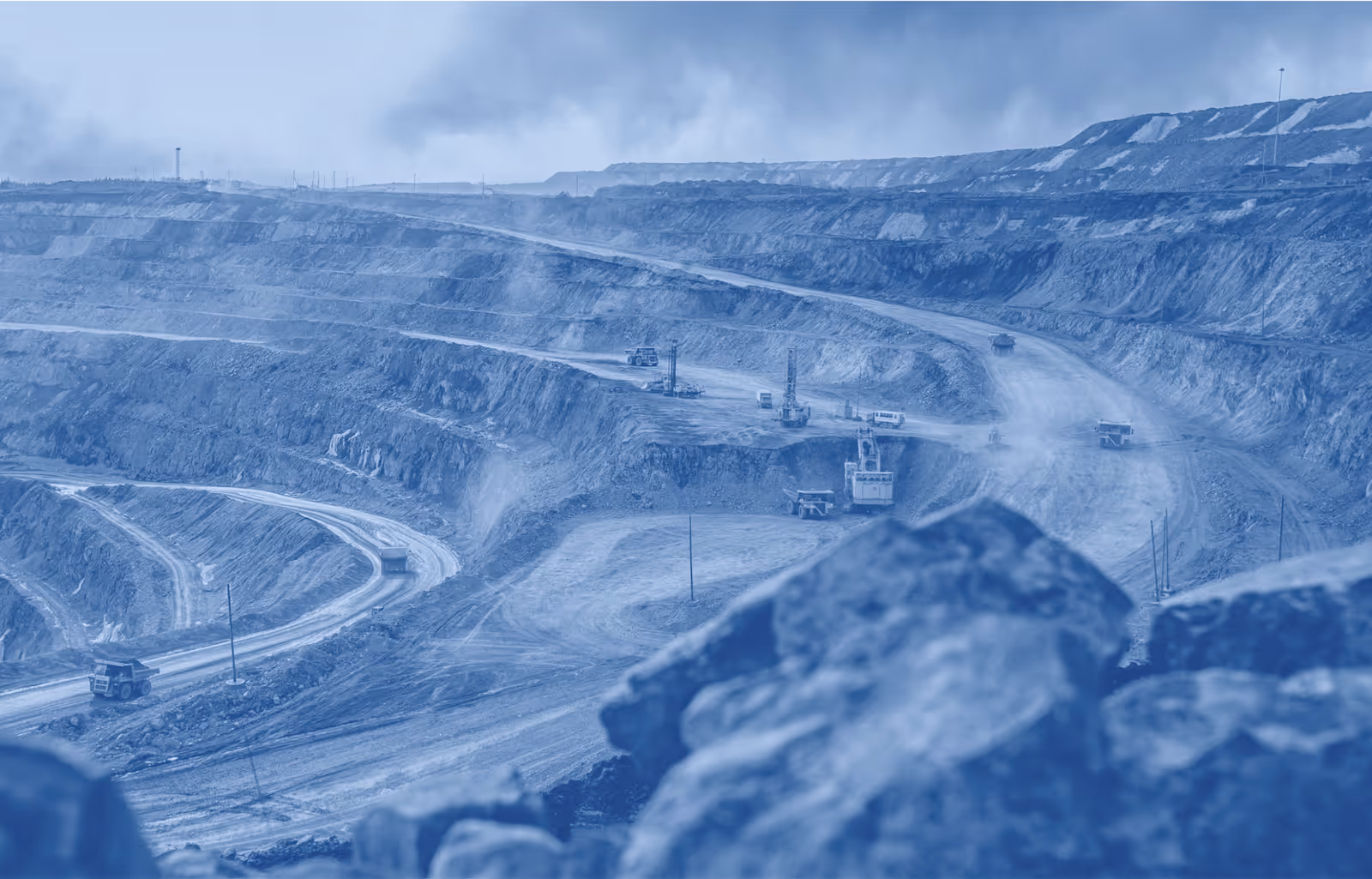 A large active mine with multiple haul trucks moving product.