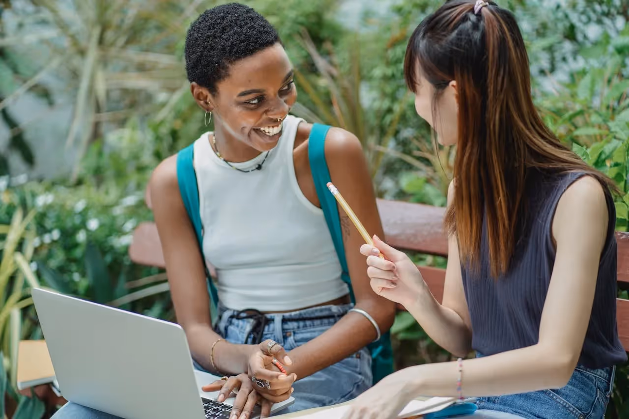 two girls talking outside while studying_IT Certification Online