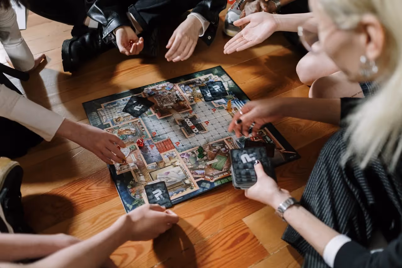 Family playing strategy board game.