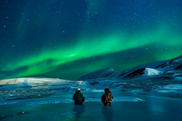Aurora Borealis over snowy mountains.