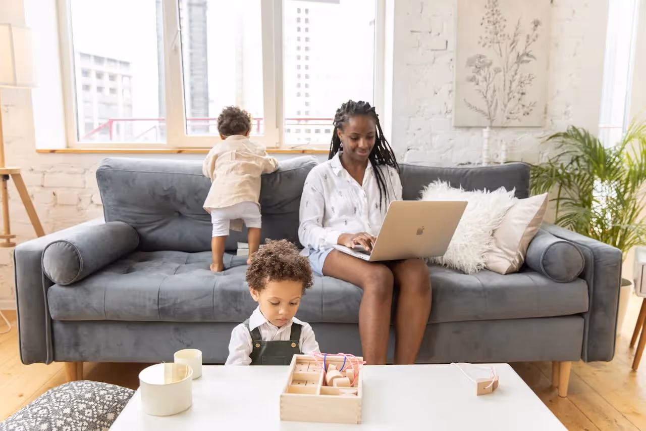 Young child studying at a desk with parent.