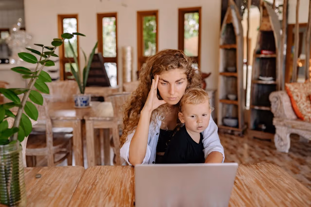 Busy mum multitasking with child at home.