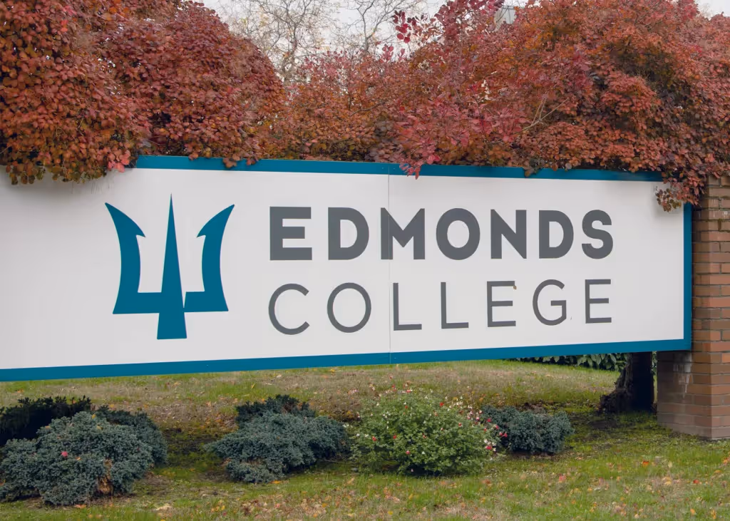 "Modern Edmonds College dorm room with bed, desk, and window"