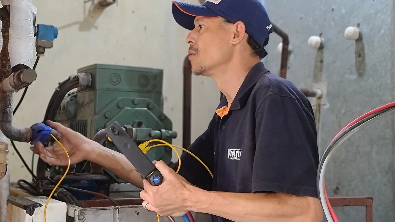 American Trade School HVAC/R Program: Technician working on HVAC unit.