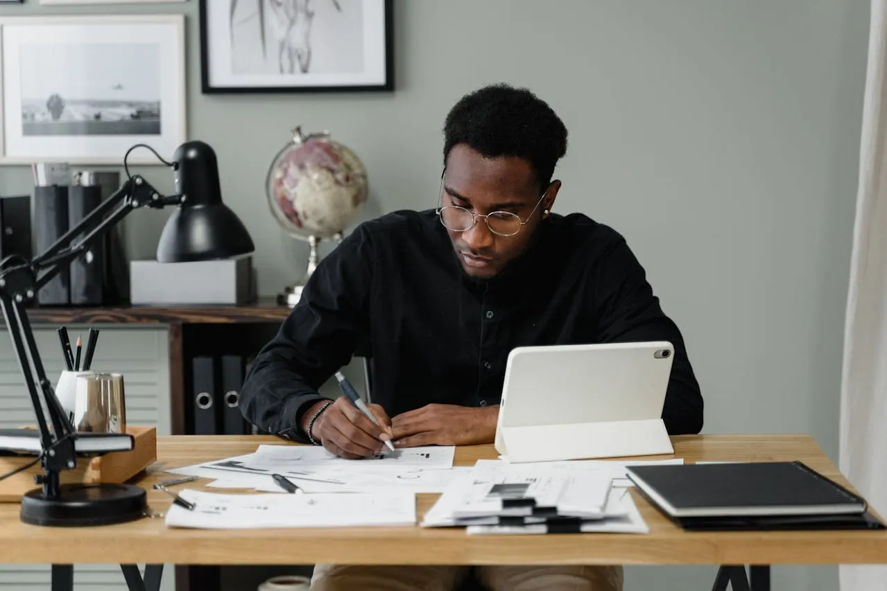 South College AS in Business Admin - Professional woman analyzing financial data in office.