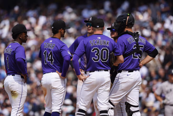 Colorado Rockies baseball team logo with purple mountains and baseball.