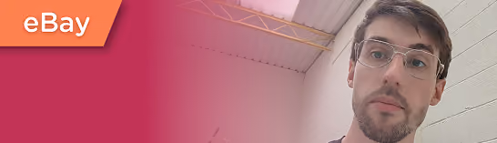 Man with glasses looking at camera with eBay logo on red gradient background to the left.