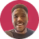 Man smiling with mouth open against a red circular background.
