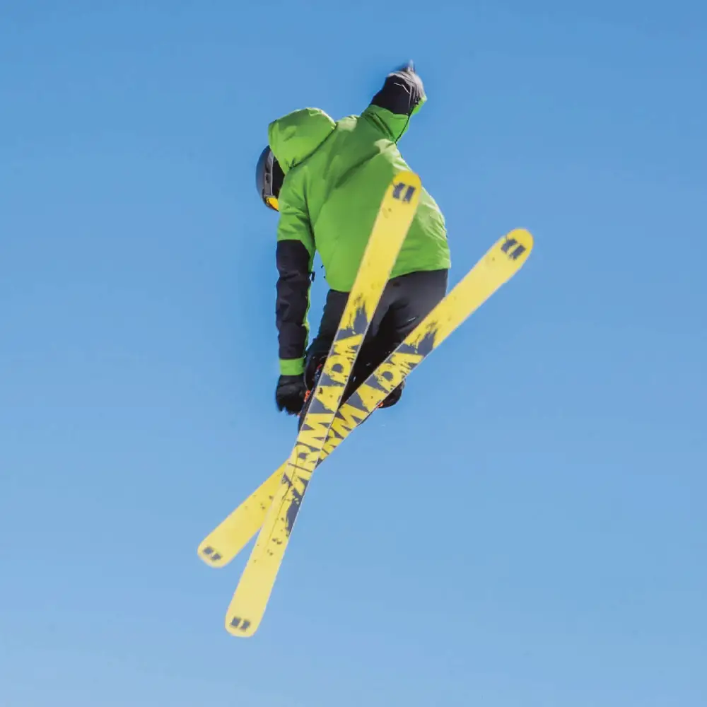 A skier appearing to fly through the air after taking a jump