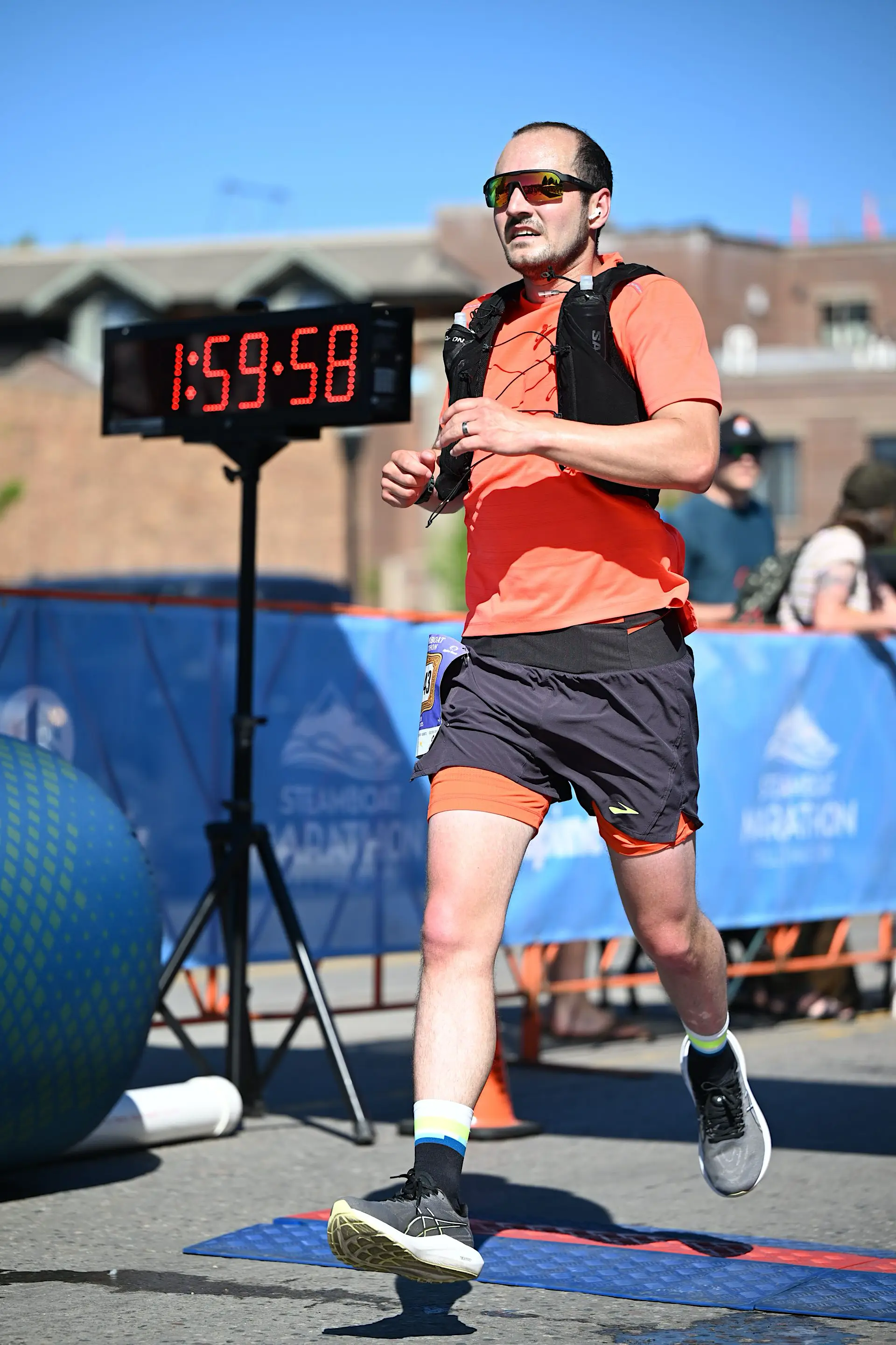 Jacob crossing a finish line wearing running attire