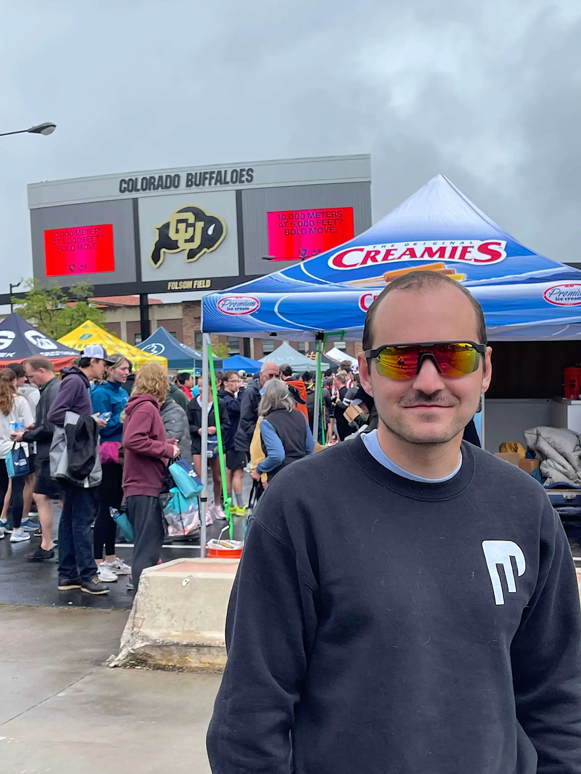 Jacob wearing sunglasses standing in front of Folsom Field in Boulder, CO