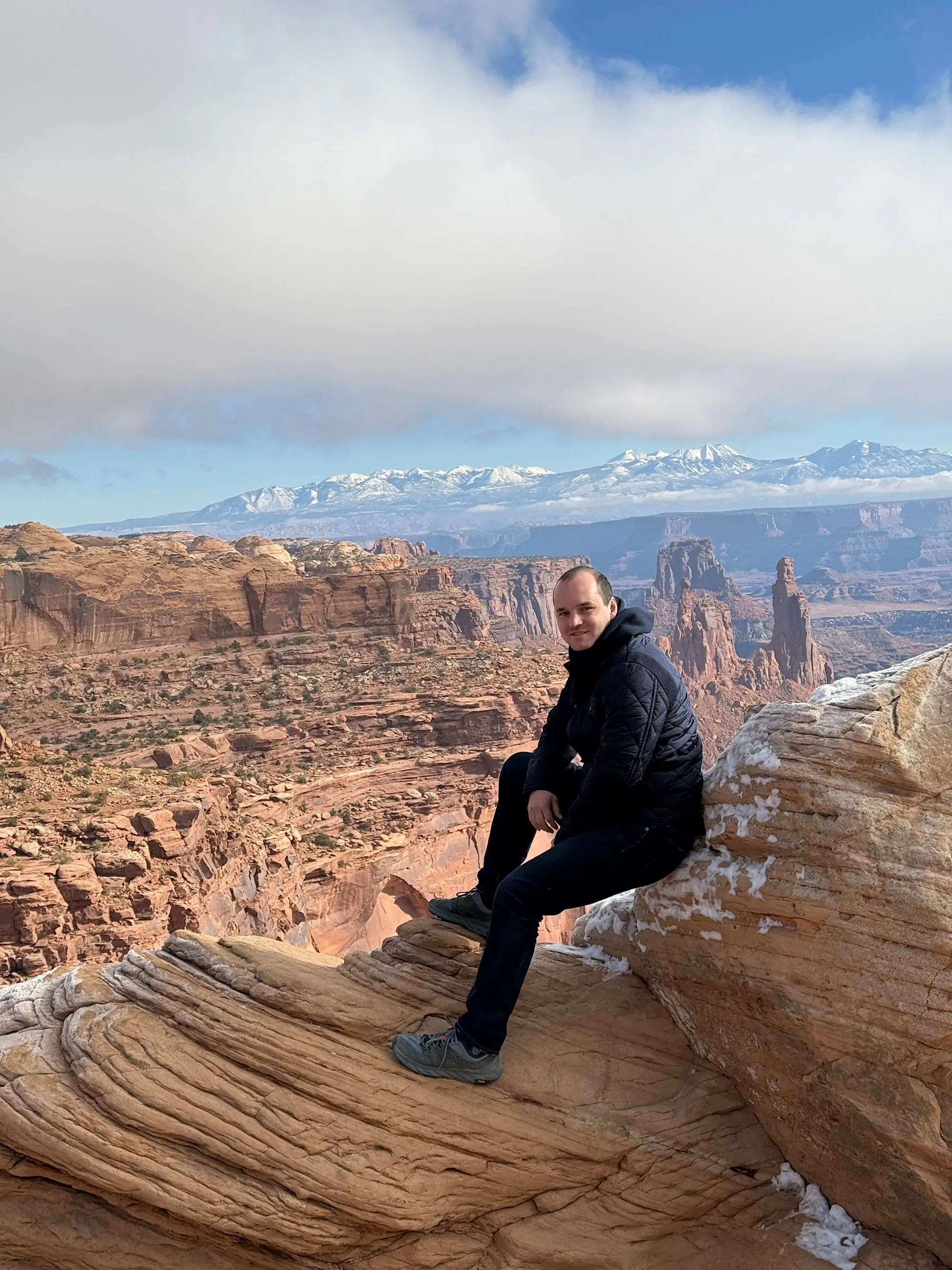 Jacob sitting on a rock above a canyon in Moab, UT