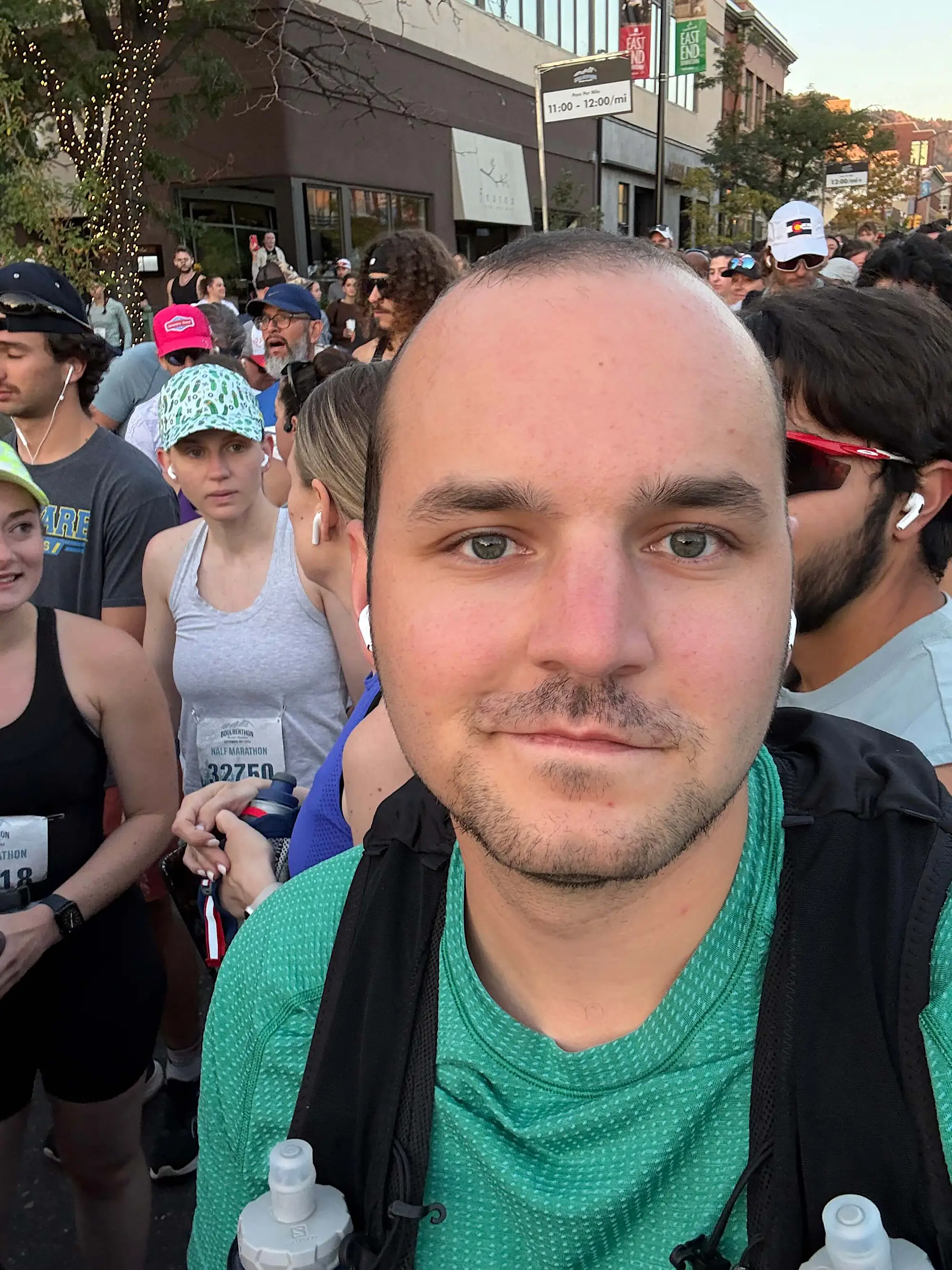 Jacob in running attire standing in a crowd of runners